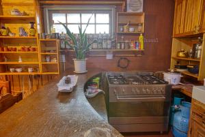 a kitchen with a stove and a counter top at Gina’s Homes in Sagada