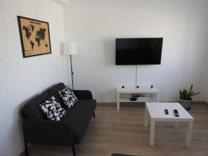 a living room with a couch and a coffee table at Seacastle Residence Peniche in Atouguia da Baleia