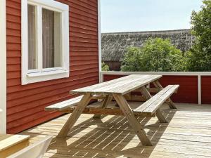 a wooden picnic table sitting on a deck at 8 person holiday home in VALDEMARSVIK in Valdemarsvik