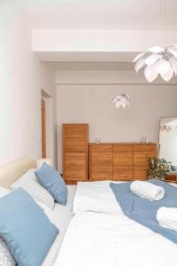 a bedroom with two beds with blue pillows at Castle View Apartment in Bratislava