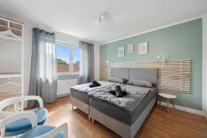 1 dormitorio con 1 cama, mesa y sillas en Amalfi Apartments A01 - gemütliche 2 Zi-Wohnung mit Boxspringbetten und smart TV, en Kaiserslautern