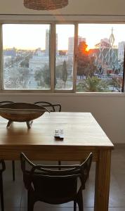 a dining room table with chairs and a view of a city at Departamento Catedral in Santa Rosa