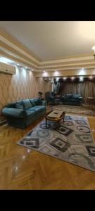 a living room with a couch and a table at VIP Apartment حامعه الدول العربيه Mohandsein in Cairo