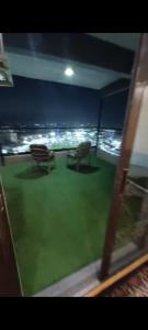a view from a window of a room with a green yard at VIP Apartment حامعه الدول العربيه Mohandsein in Cairo