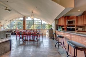 a kitchen and dining room with a table and chairs at The Royal Suite - Village Penthouse, Private Hot Tub with Mountain Views in Whistler
