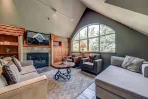a living room with a couch and a fireplace at The Royal Suite - Village Penthouse, Private Hot Tub with Mountain Views in Whistler