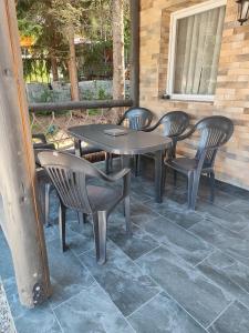 a table and chairs sitting on a patio at Woodland house in Sîntimbru-Băi