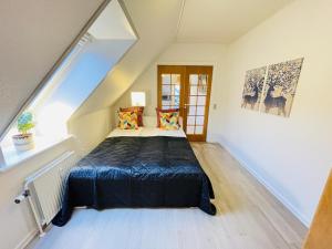 ein Schlafzimmer mit einem großen Bett im Dachgeschoss in der Unterkunft aday - Great 1 bedroom central apartment in Hjørring
