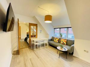 ein Wohnzimmer mit einem Sofa und einem Tisch in der Unterkunft aday - Great 1 bedroom central apartment in Hjørring