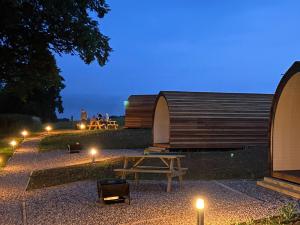 a picnic table and a tent at night with lights at Althorp - Ukc5322 in East Haddon