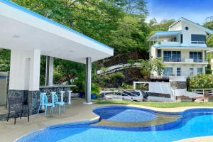 a villa with a swimming pool and a house at Casa Hola in Coco