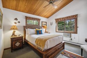 a bedroom with a bed and a wooden ceiling at Good Medicine Lodge in Whitefish