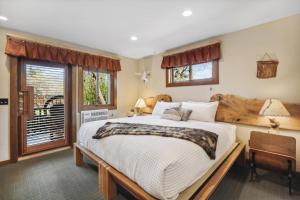 a bedroom with a large bed and a window at Good Medicine Lodge in Whitefish