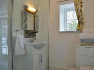 a bathroom with a sink and a shower at The Cider Barn in Presteigne