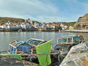 a group of boats parked on the shore of a body of water at Prior Dene Cottage in Staintondale