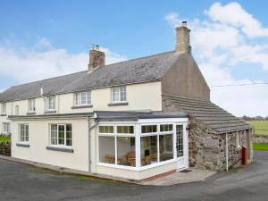 an extension to a house with a conservatory at Dunstanburgh View in Craster