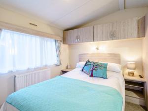 a bedroom with a large bed and a window at The Paddocks - Uk7112 in Dollar
