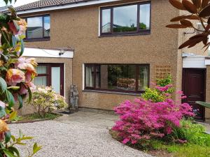a house with windows and flowers in front of it at Argyle View in Dunblane