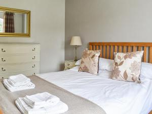 a bedroom with a bed with towels on it at The Dairy At Brook House Farm-uk40631 in Church Minshull