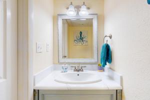a bathroom with a sink and a mirror at Sand Dollar W202 in Pensacola Beach +19 photos