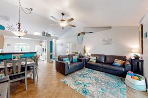a living room with a couch and a table at Eastwood Hideaway in Fort Pierce