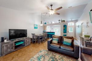 a living room with a couch and a tv at Eastwood Hideaway in Fort Pierce