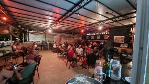 a group of people sitting at tables in a restaurant at Hostel best offer in Dubrovnik