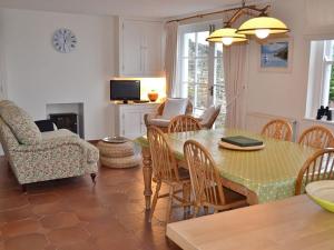 a kitchen and living room with a table and chairs at Roadstead in Fowey