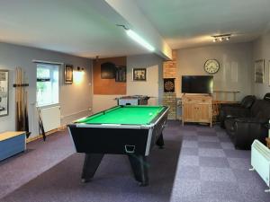 a living room with a pool table in it at Squirrels Drey in North Walsham