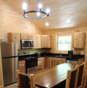 cocina con armarios de madera y mesa de madera en 211 Misty Mountain Getaway, en Gatlinburg