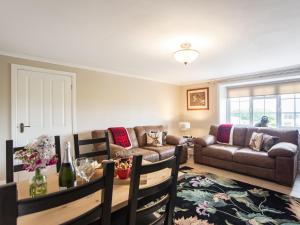 a living room with a couch and a table at Flossys House -uk35020 in Chatton
