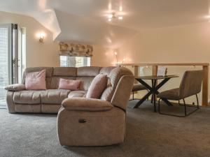 a living room with a couch and a table at Kinneret Apartment in Silsden