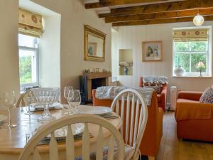 a dining room and living room with a table and chairs at Felicity House in Staithes