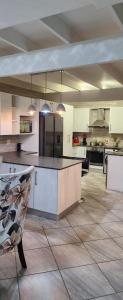 a large kitchen with a island in the middle at The Holiday House in Hartbeespoort
