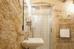 a bathroom with a sink and a shower at Dar Isla, in the heart of the Three Cities, Malta in Senglea