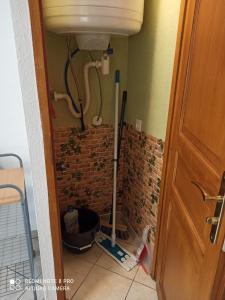 a bathroom with a sink and a brick wall at Le bien vivre in Wittenheim