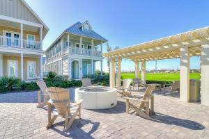 a patio with chairs and a fountain in front of a house at Golf Course Living at Palmilla Beach in Port Aransas