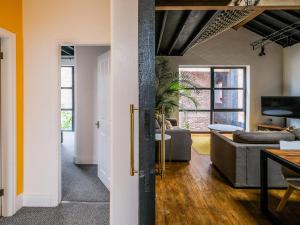 a living room with a couch and a table at The Gold Apartment - UK40025 in Southport