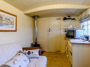 a small kitchen with a bed and a microwave at The Lambing Shed in Ryhill