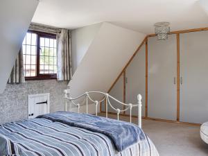 a bedroom with a bed and a staircase at Leighwood in Sandwich