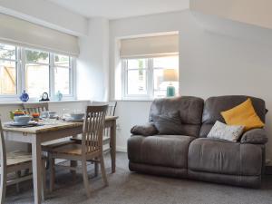 a living room with a table and a couch at Shepley Mews in Glossop