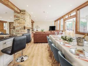 a dining room with a long table and chairs at Chapel Barn in Bolnhurst