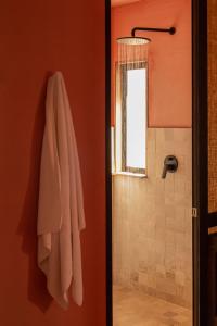a bathroom with a towel hanging on a wall at Our Habitas San Miguel de Allende in San Miguel de Allende +80 photos