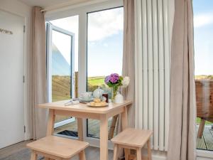 a room with a table and a large window at Meadows Edge - Uk30951 in Perranzabuloe