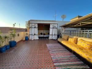 an outdoor patio with a couch on a building at Riad Mama Toutou in Marrakesh