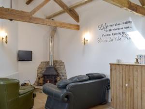 a living room with a couch and a fireplace at Pipistrelle Cottage - Uk34447 in Mathry