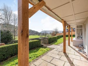 a view of the garden from the porch of a house at Arfryn in Carno