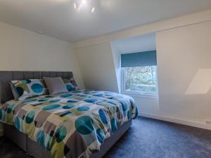 a bedroom with a bed and a window at Toadlands Farm in Eastville