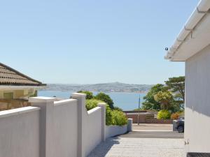 a white fence with a view of the water at Deepwater Point Apartment in Torquay