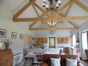 a kitchen with a table and a dining room at Fossils End in Chickerell